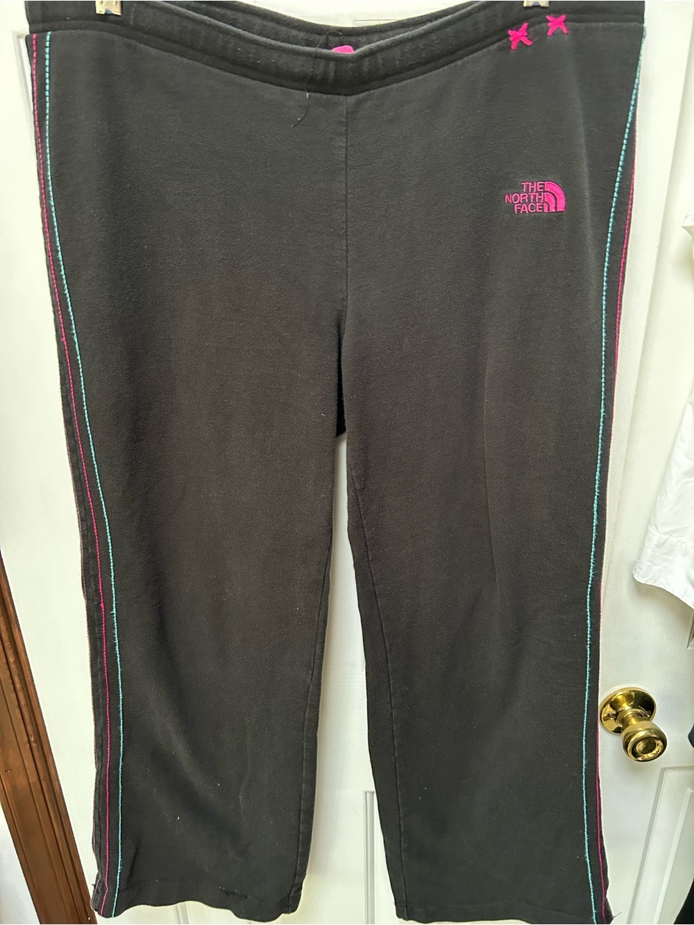 The North Face Black Sweatpants with Pink Logo Contrast Piping. Drawstring waist